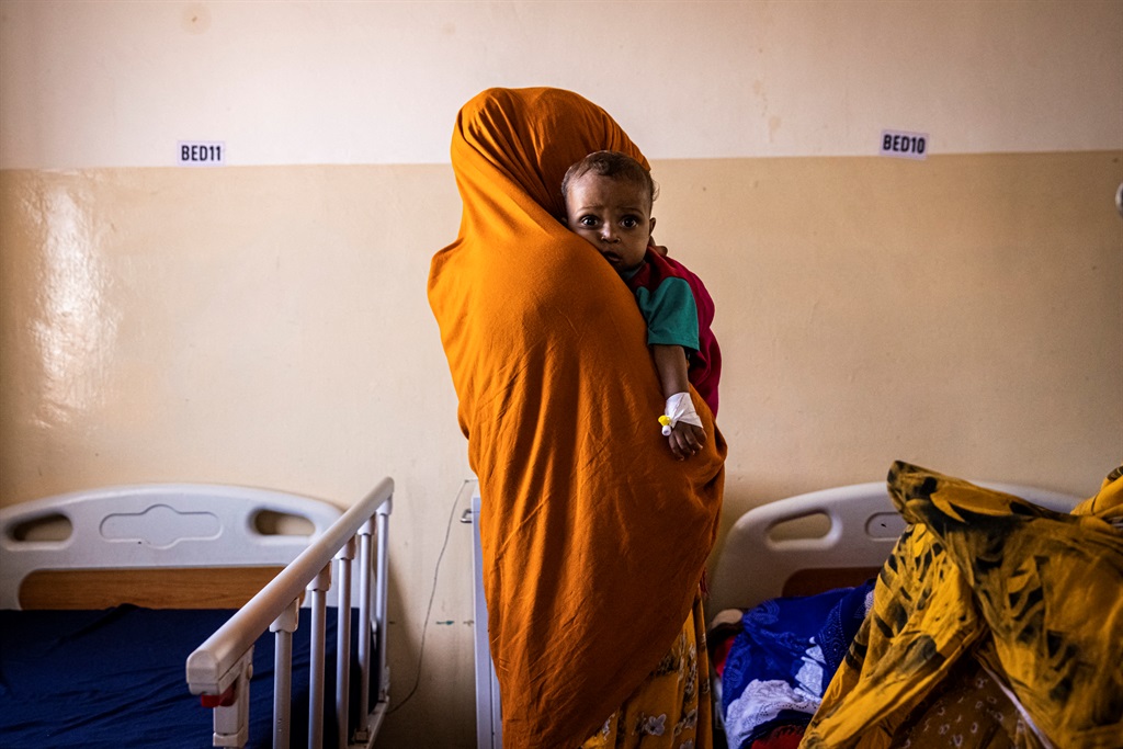 A mother holds her malnourished baby in Banadir Maternity and Children Hospital in Mogadishu, Somalia, on June 1, 2022.