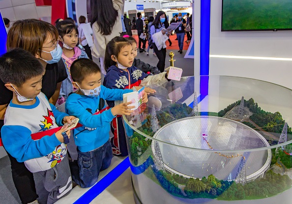 Visitors watch a model of the 500-meter aperture spherical radio telescope (FAST), also known as Chinas Sky Eye, during the 4th Digital China Summit at Fuzhou Strait International Conference and Exhibition Center on April 26, 2021 in Fuzhou, Fujian Province of China. (Photo by Yang Enuo/VCG via Getty Images)
