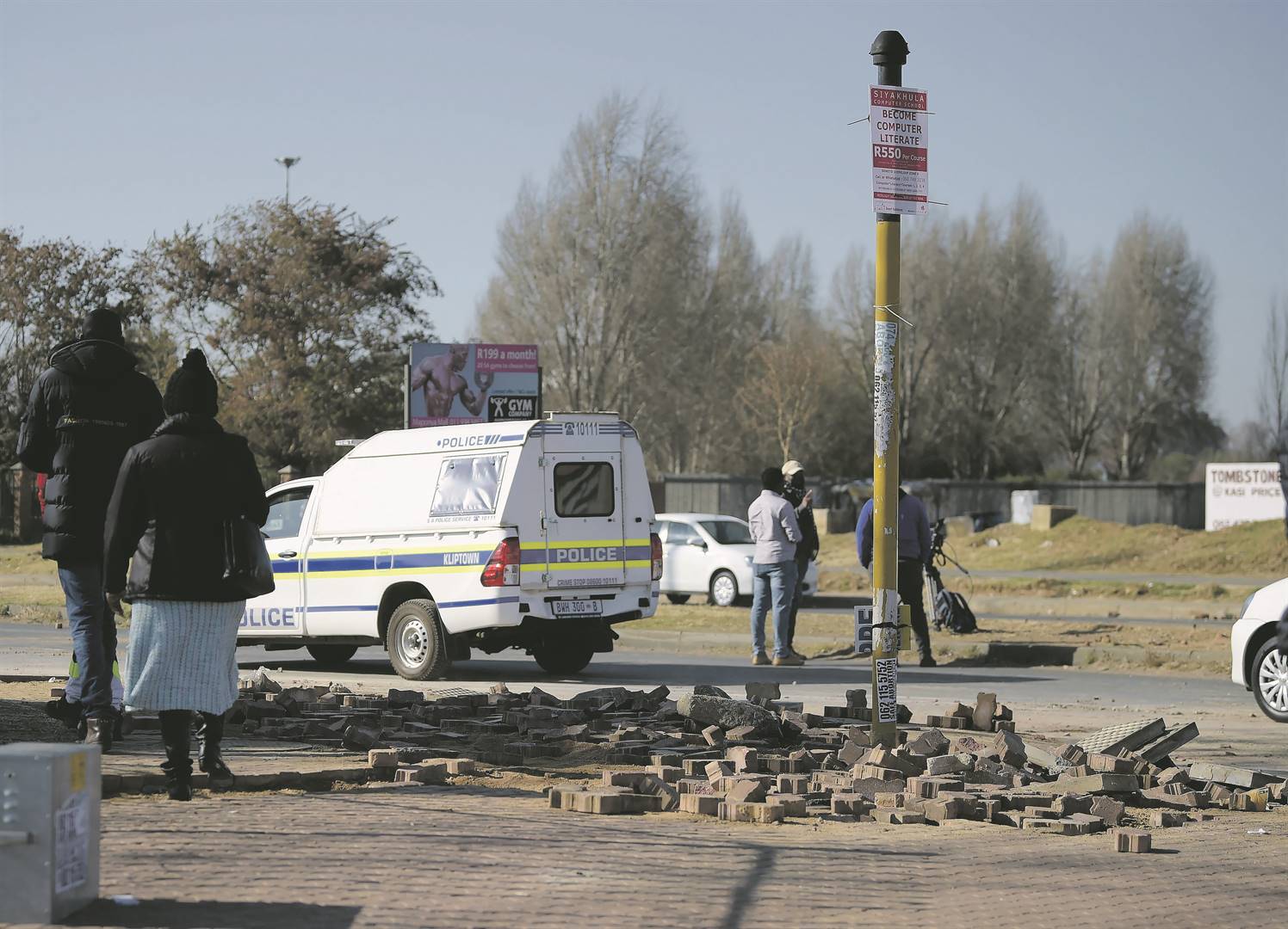 Protesters in Pimville, Soweto, removed the paving on the pavement and used the bricks to block Chris Hani Road.             Photo by Trevor Kunene