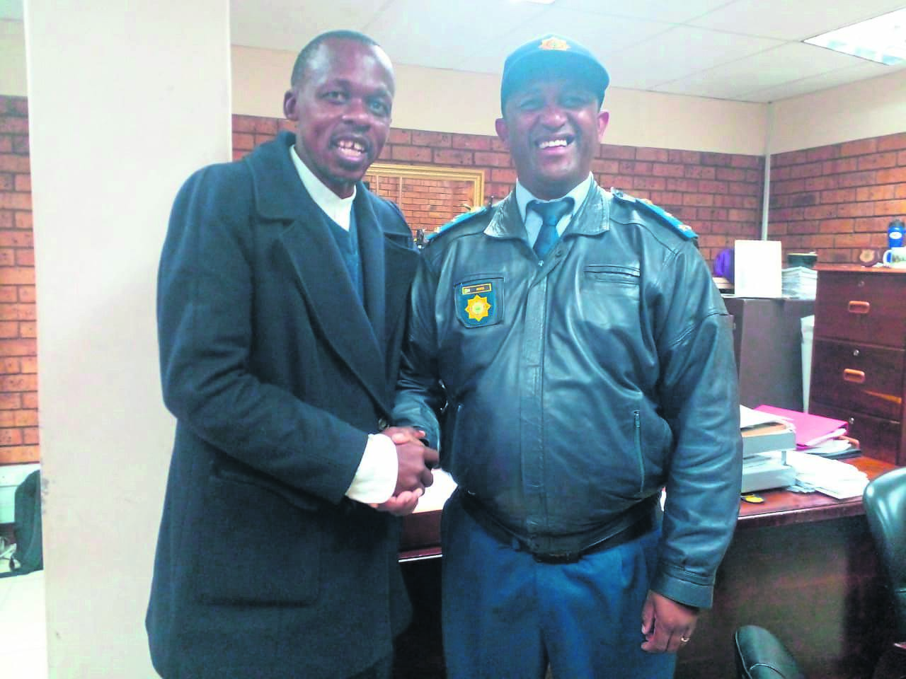 Nyanga CPF secretary, Dumisani Qwebe, congratulates Brigadier Vuyisile Ncata on his promotion to the rank of major-general in the Eastern Cape. Photo by Lulekwa Mbadamane