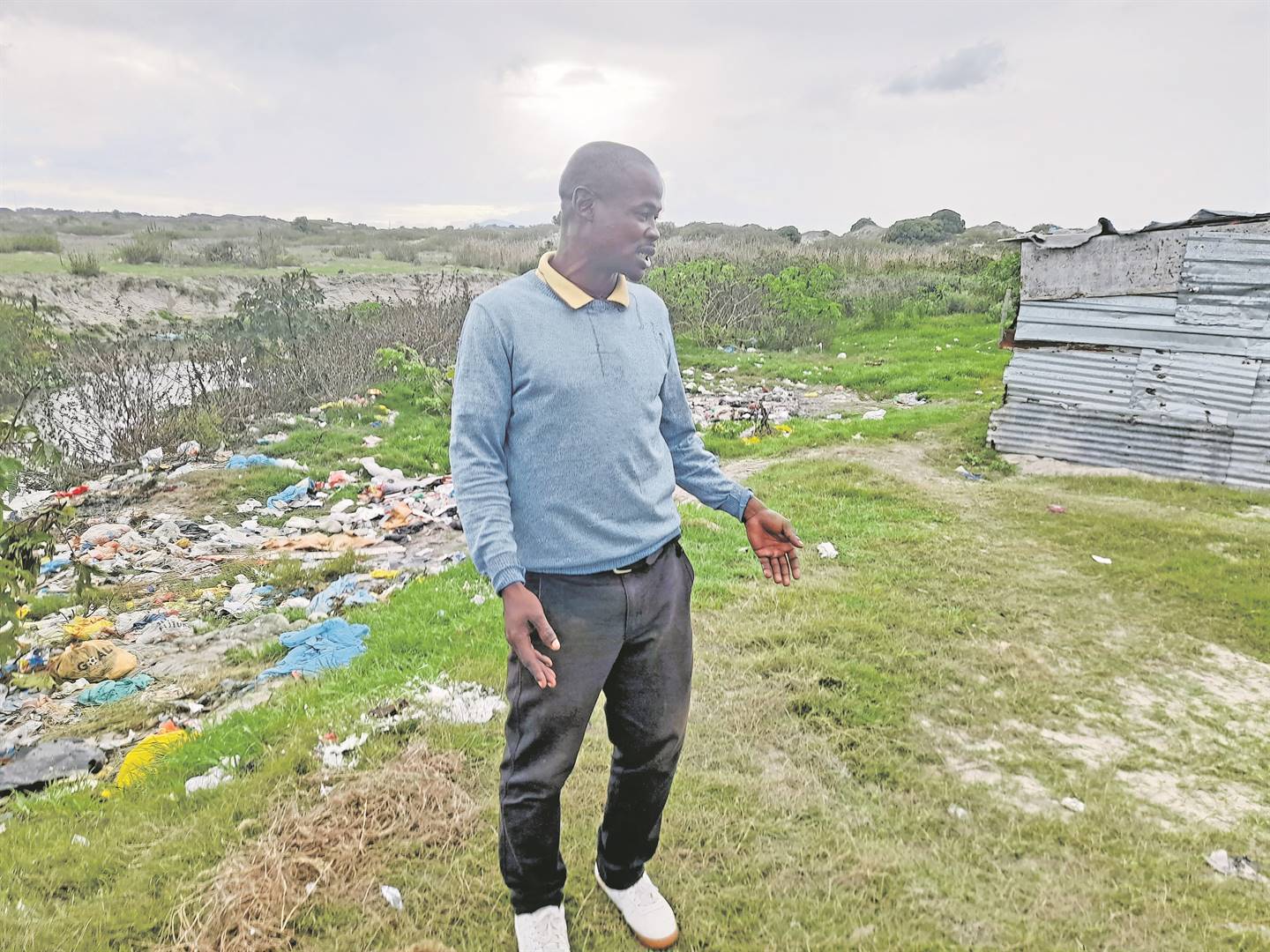 Brandon Qhanga from Dubai informal settlement, in Cape Town, said people use the open space behind his shack to relieve themselves.          Photo by Lulekwa Mbadamane