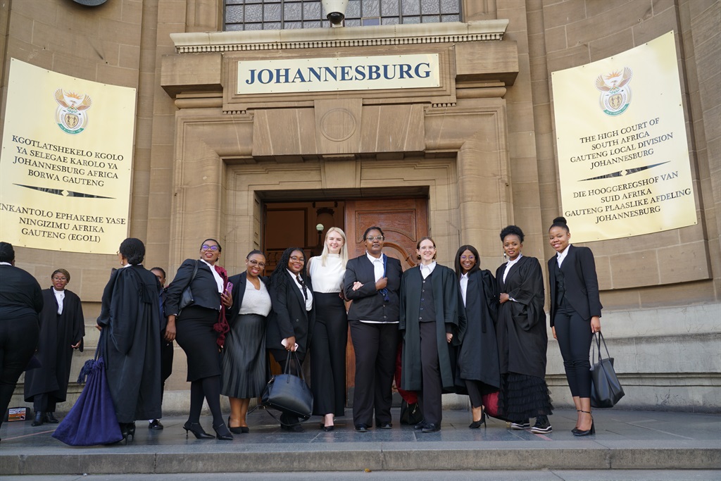 Group of women in law posing outside court