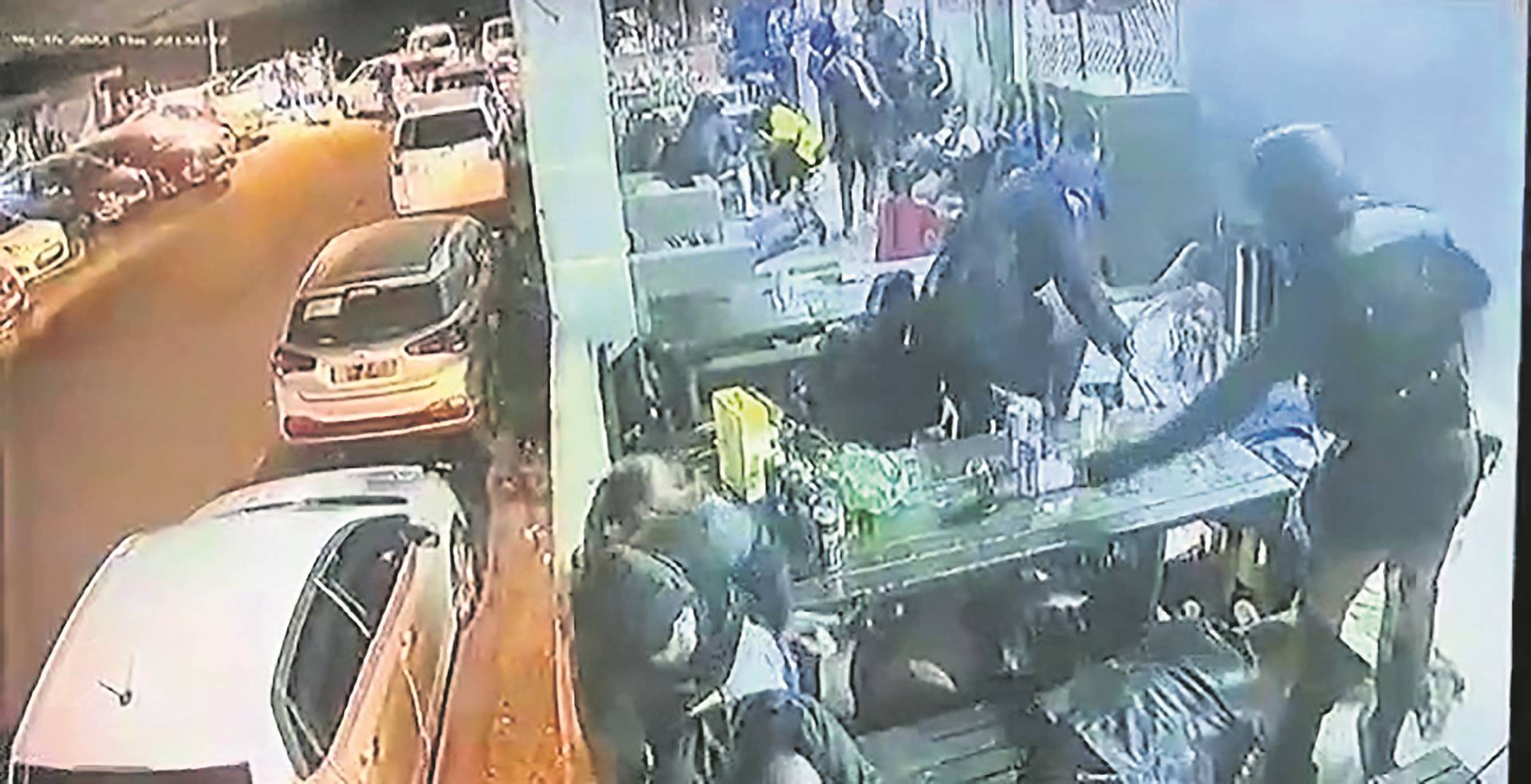 Screengrabs taken from a video in which cops are seen arriving at one of the shisa nyamas in Umlazi, shouting and kicking patrons.