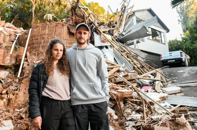 Tia-Louise Talbot and fiancé Damian Stone in front of her parents’ house that was destroyed by mudslides during the KwaZulu-Natal floods. (PHOTO: Darren Stewart)