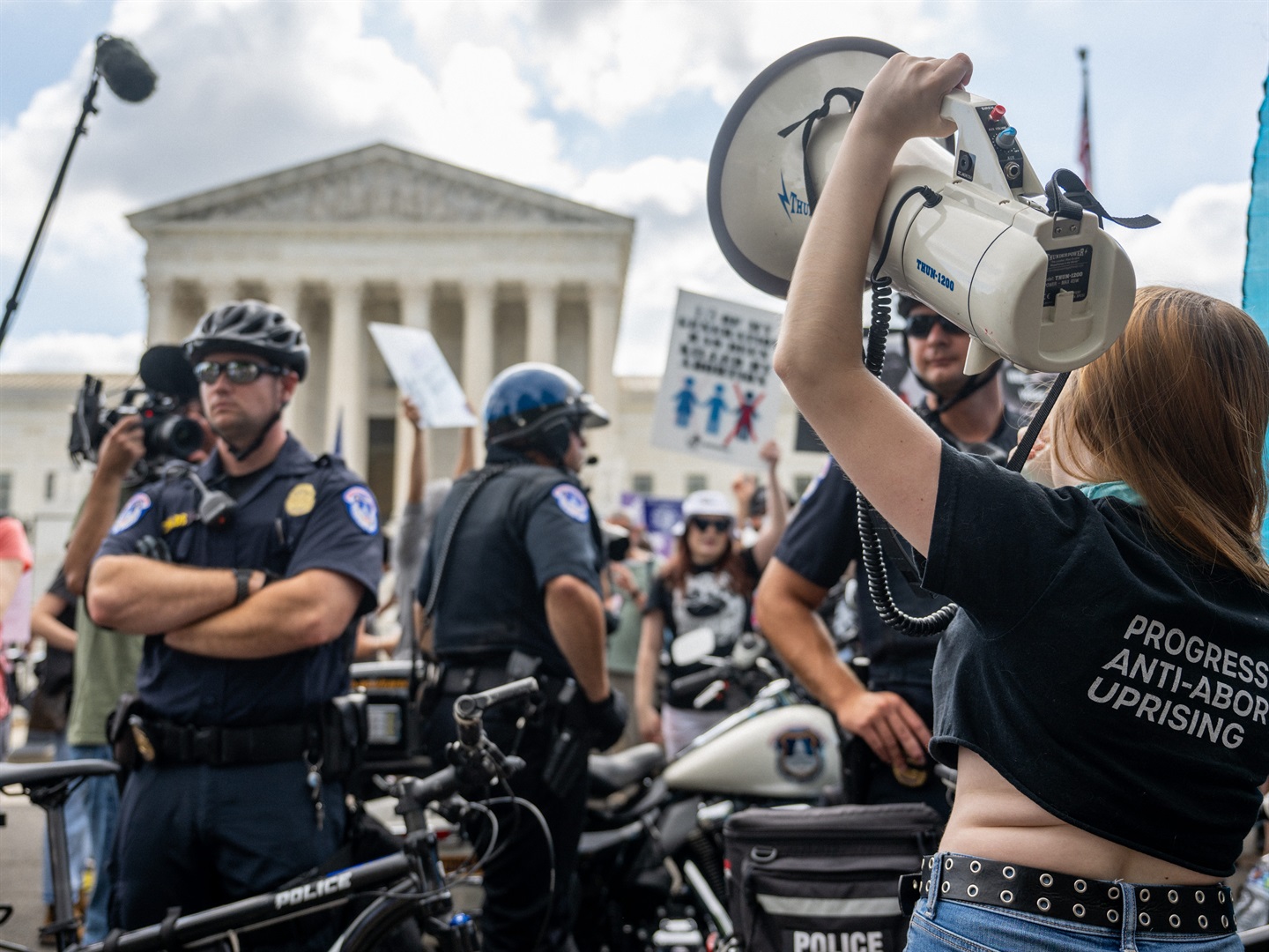 Capitol Police line the US Supreme Court building as protestors crowd the outside.