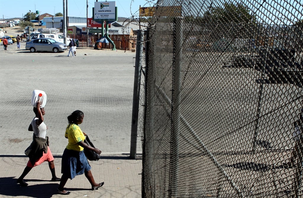 Two women cross the border from Zimbabwe into South Africa at the Beitbridge post.