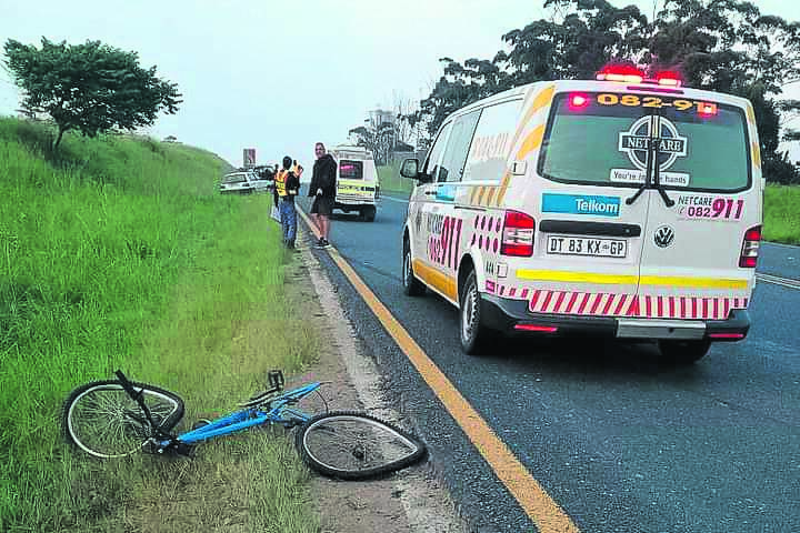Police and paramedics at the scene in Sundra, Mpumalanga, where a cyclist was allegedly killed by hijacking suspects. 