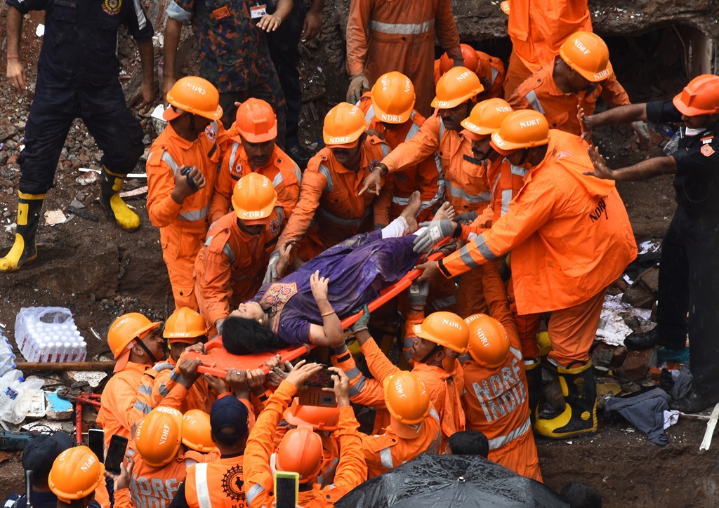 At least three people were killed and dozens were feared trapped after a four-storey building collapsed in India. (Photo by Imtiyaz Shaikh/Anadolu Agency via Getty Images)