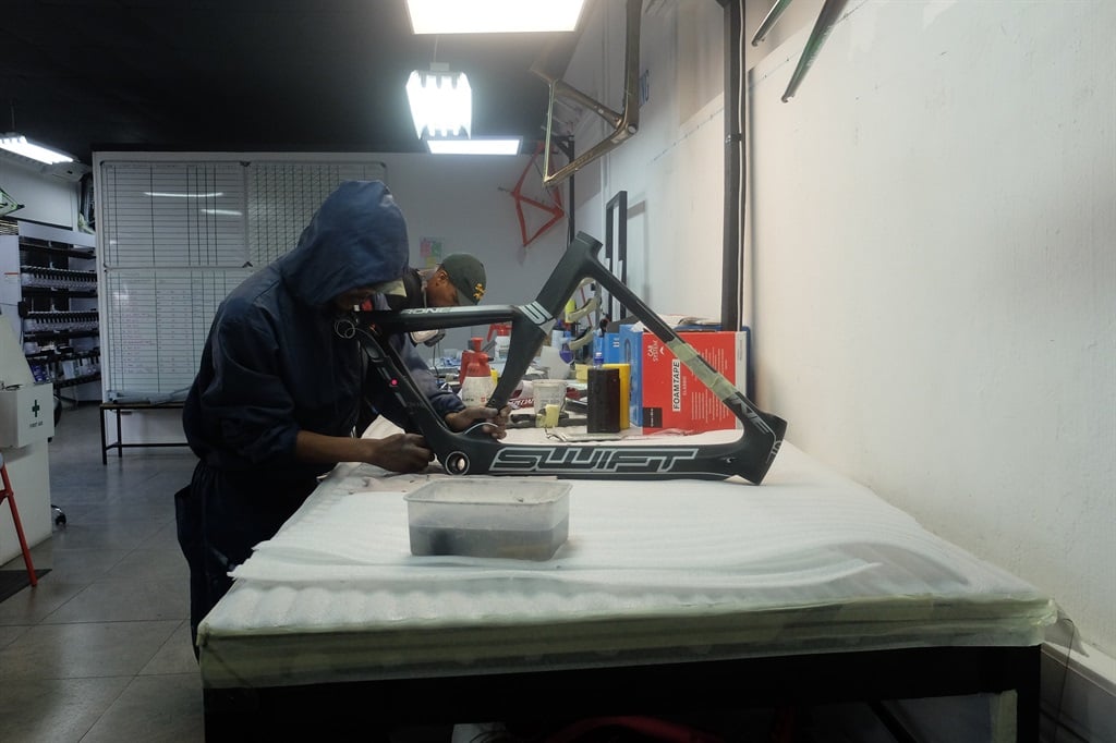 A technician busy repairing a frame in Carbon Fibre Bike Repair SA’s workshop. (Photo: Reuben van Niekerk) 