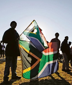 High school pupils carry SA flags to commemorate Youth Day in Soweto on June 16 this year. PHOTO: Cornell Tukiri / Anadolu Agency / Getty Images