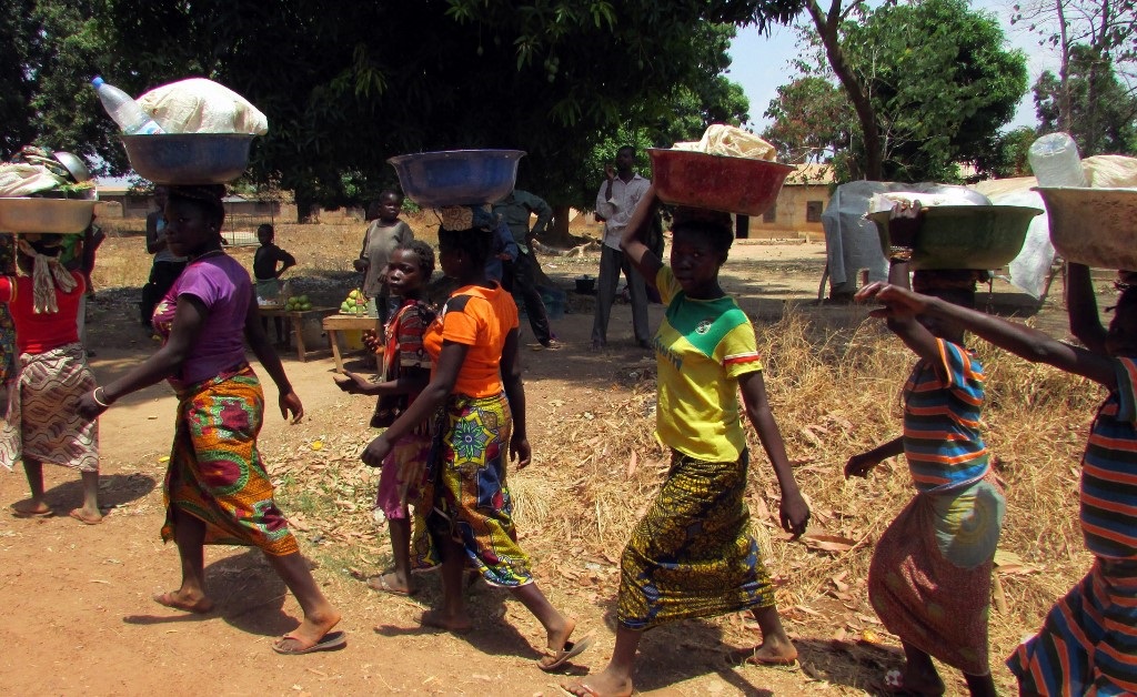 Residents carry their goods during a visit by the executive director of the United Nations World Food Programme.
