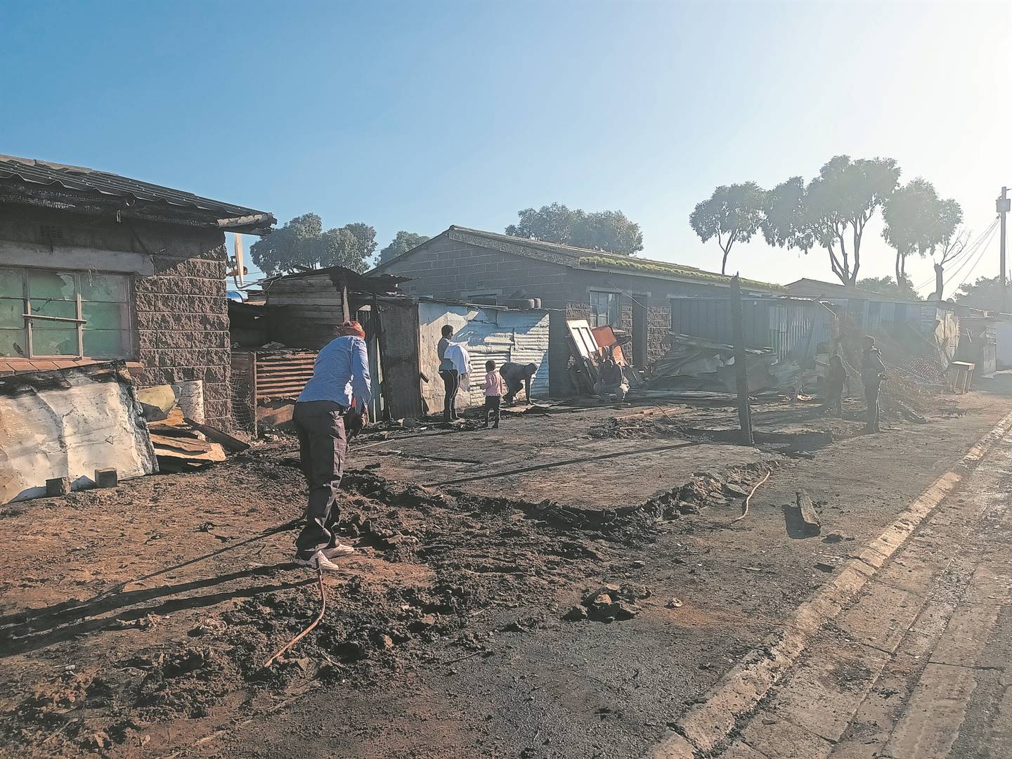Some fire victims clear the rubble from their sites although they are now sure how they will rebuild.PHOTO: UNATHI OBOSE