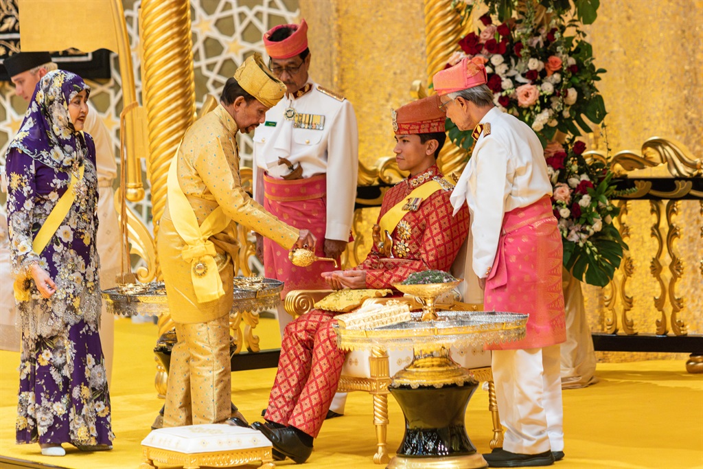 Brunei's Sultan Hassanal Bolkiah pouring scented o