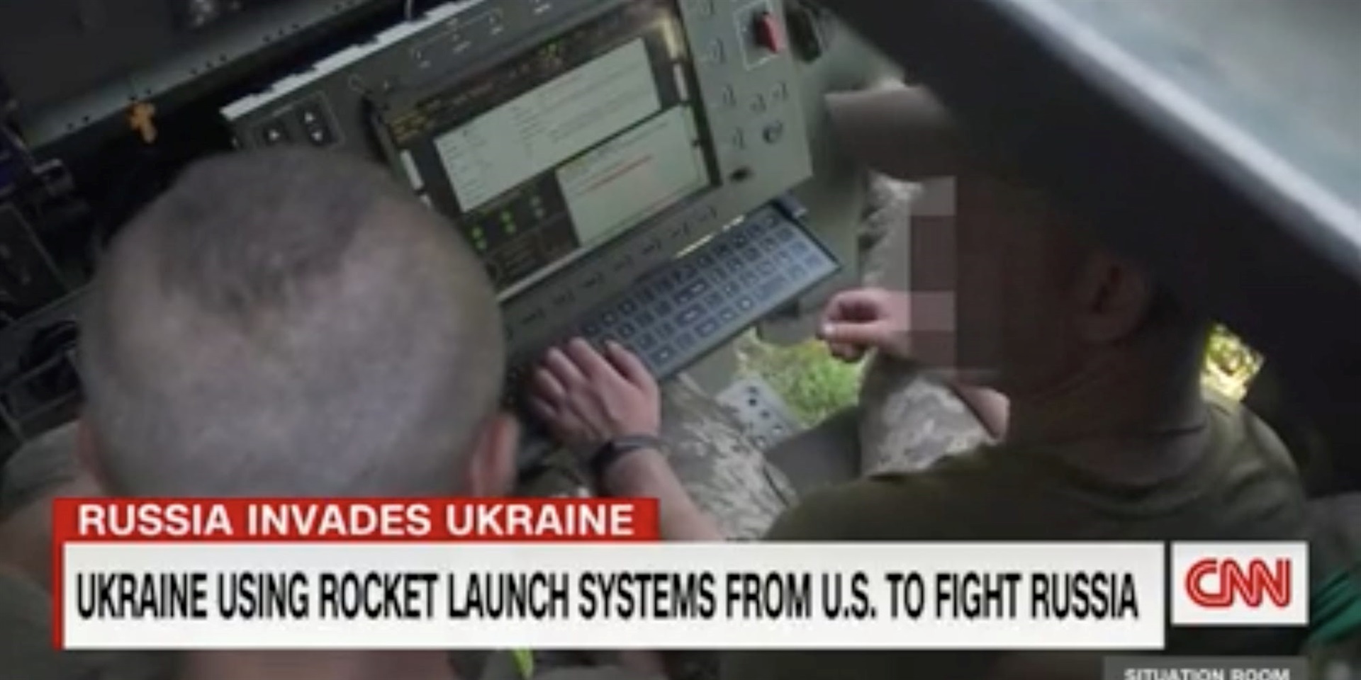 Two Ukrainian soldiers inside a US-donated HIMARS truck. CNN