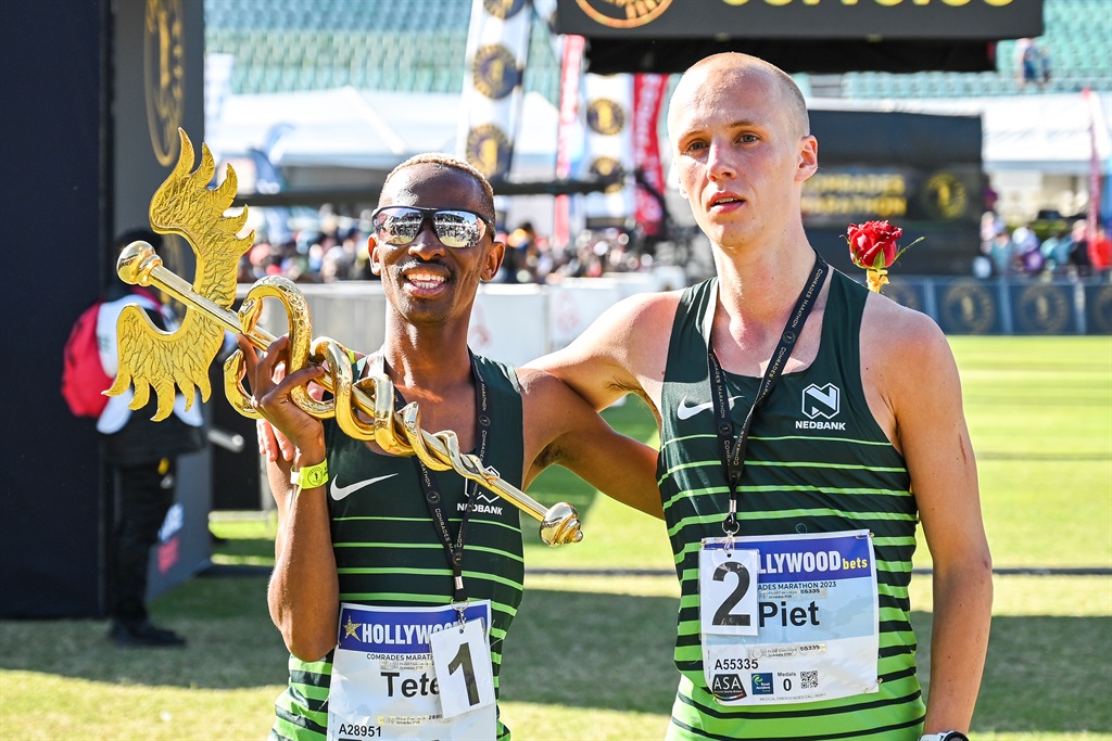 Comrades Marathon down run champion Tete Dijana and runner-up Piet Wiersma of the Netherlands at the finish line at Hollywoodbets Kingsmead Stadium in Durban.. Photo: Darren Stewart/Gallo Images