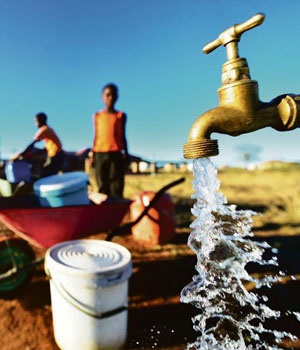 Community members fill buckets with water from a communal tap in a village outside Senwabarwana in Limpopo. Continued underspending by the water and sanitation department is likely to result in further deterioration of infrastructure. Picture: Leon Sadiki