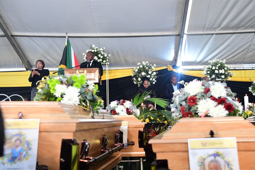 Cyril Ramaphosa at podium with coffins below
