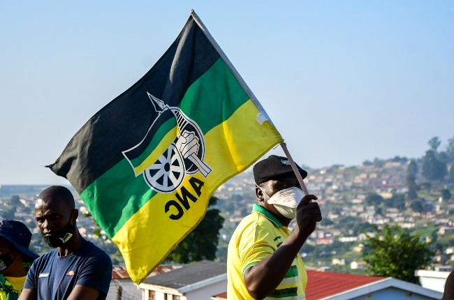 An ANC supporter waves a flag. 