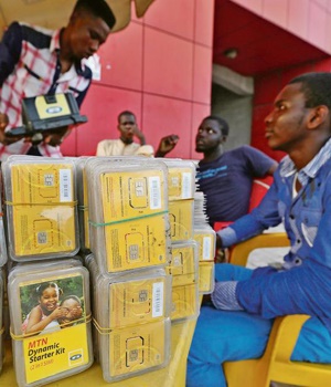 People who sell MTN SIM cards wait for customers at a roadside kiosk in Lagos, Nigeria,