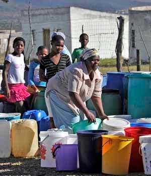 Gertrude Siwela lines up containers alongside those of other community members as they wait for a water tanker. Picture: Tebogo Letsie