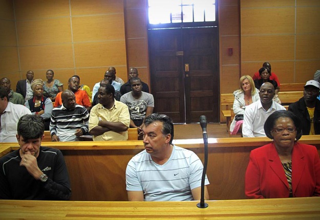 Former Limpopo MEC for Health and Social Development, Merriam Segabutla, her two accomplices, Johnny Lucas and Pieter Erasmus, in court and getting instruction from their lawyer. Picture: Marietie Louw-Carstens