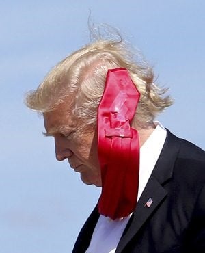 Wind blows President Donald Trump's tie as he arrives at Orlando International Airport. (Joe Burbank, Orlando Sentinel via AP)