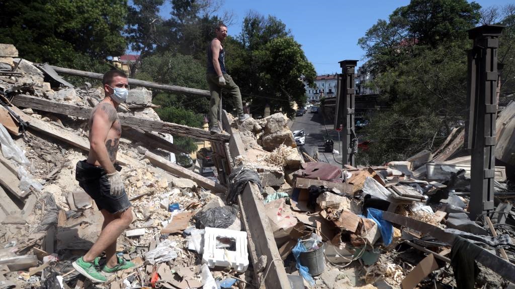 Workers clear the rubble in the centre of Odesa on