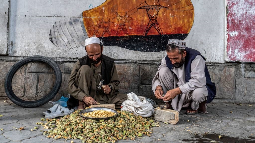Afghan vendors sell almonds along a street in the 