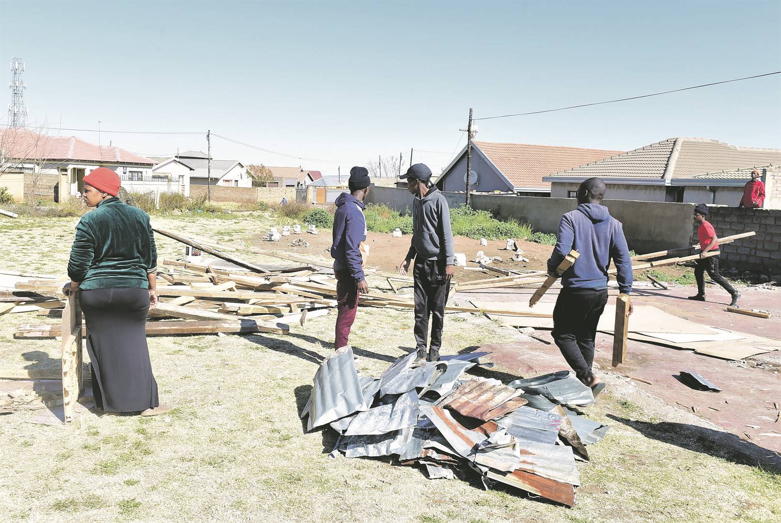 Members of St Paul Apostolic Faith Mission International in Mohlakeng try to salvage what is left of their church, which they said cost R50 000 to build.              Photo by Morapedi Mashashe