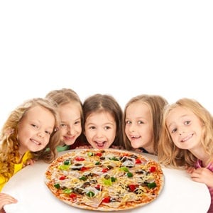 Kids eating a big pizza.