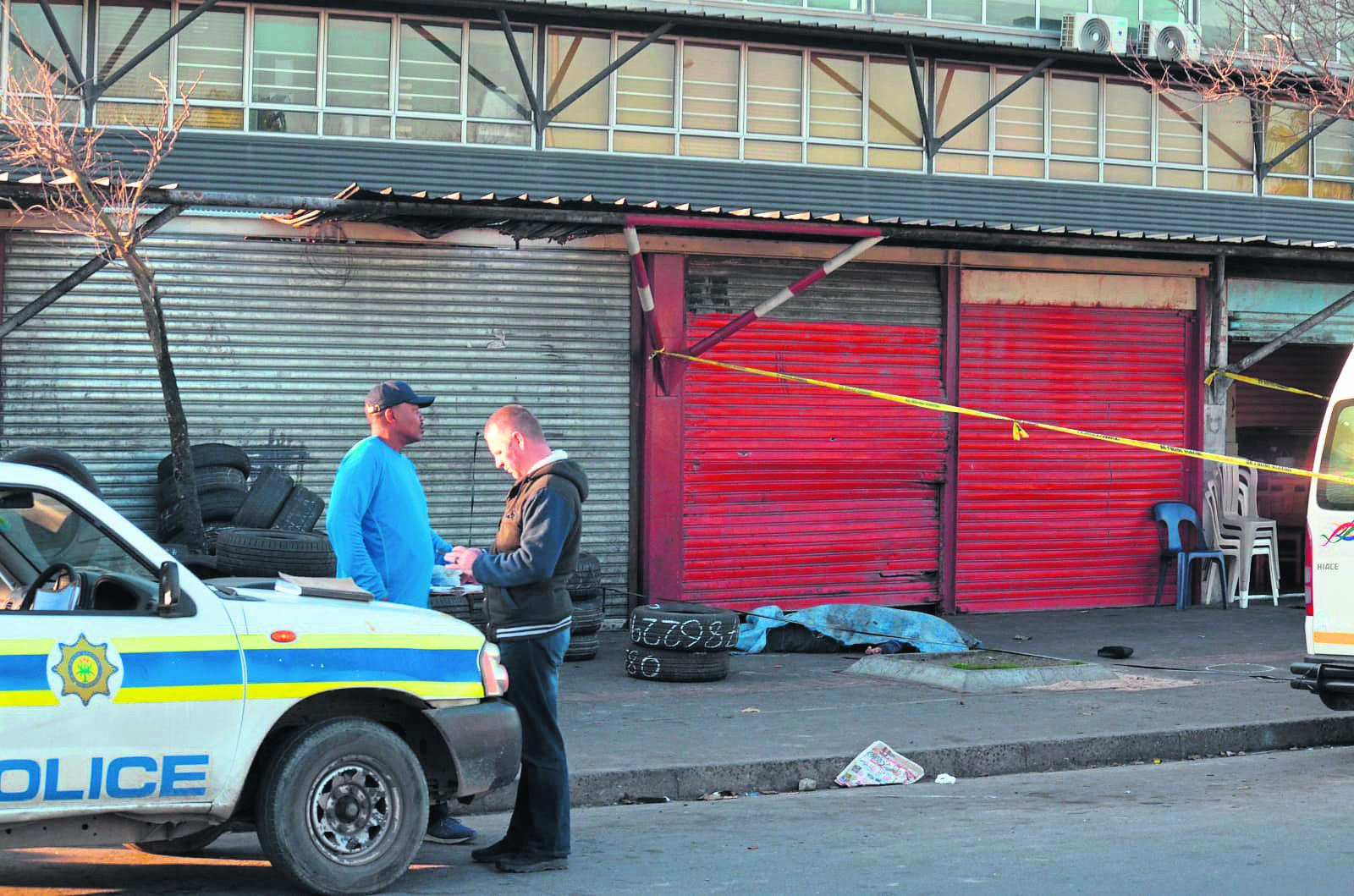 Police at the scene where a taxi operator was gunned down in Gugulethu on Saturday.               Photo by                      Lulekwa Mbadamane 