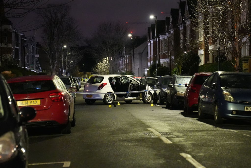 Police at the scene of an incident near Clapham Common, south London, after a suspected corrosive substance was thrown at a woman and her two young children. 