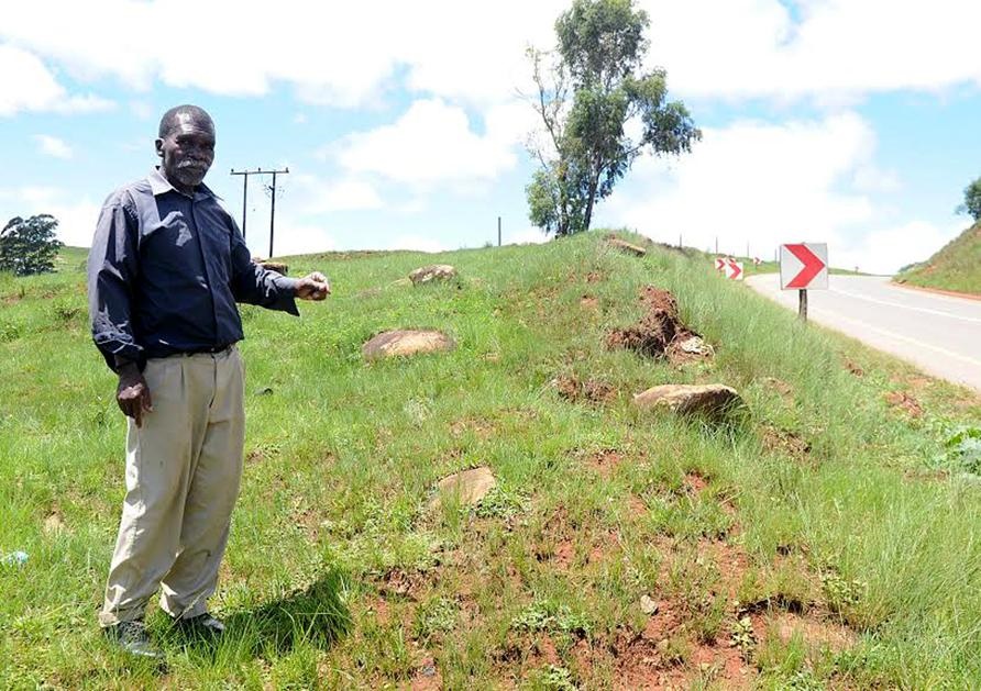 GRAVE PROBLEM: Induna Robert Ngcobo points out the old graves near Ehhashini bus stop. Photo by Jabulani Langa