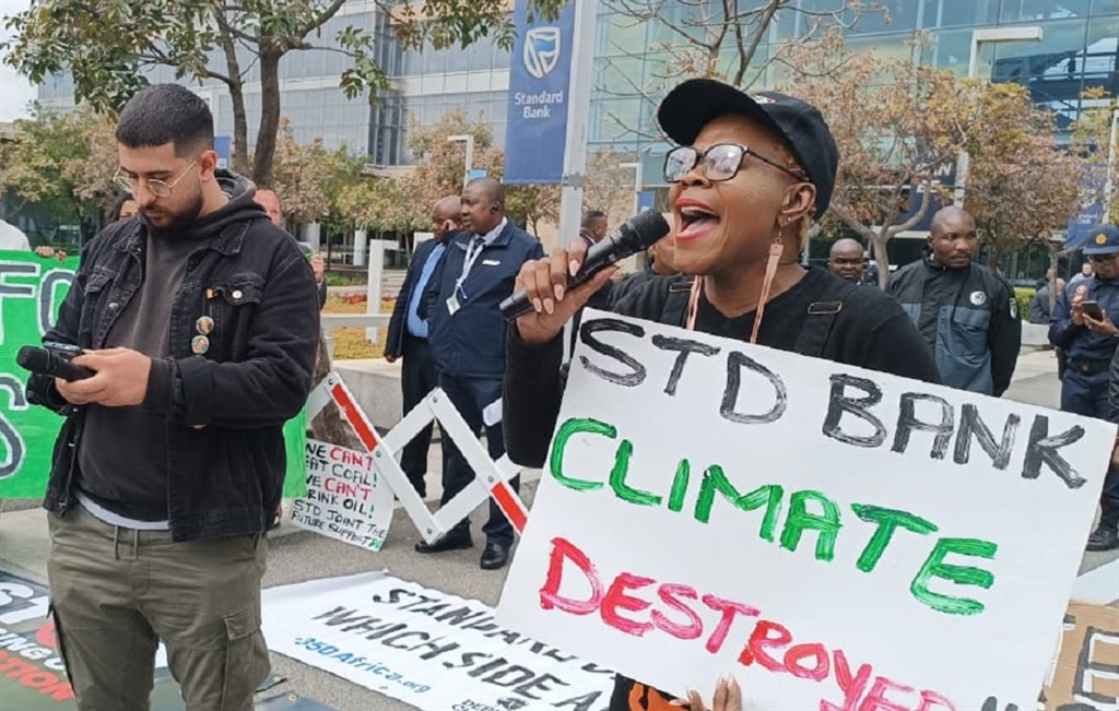 Earthlife Africa Johannesburg and other environmental activists gather outside Standard Bank's offices in Johannesburg. They speak out against the bank's involvement in the East African Crude Oil Pipeline.