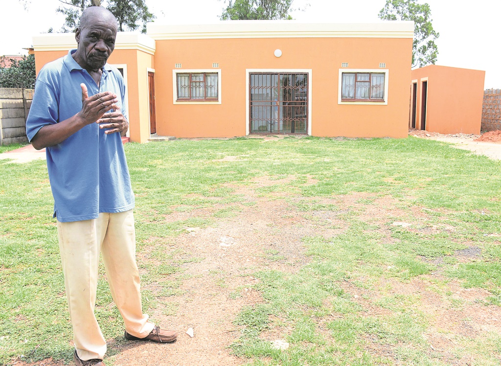 Landlord Mbuso Mthimkhulu stands next to the rooms his tenant built in his yard.     Photo by Muntu Nkosi   