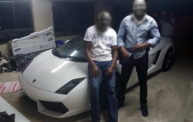 The suspect posing with the Lamborghini. 
Image by: Supplied