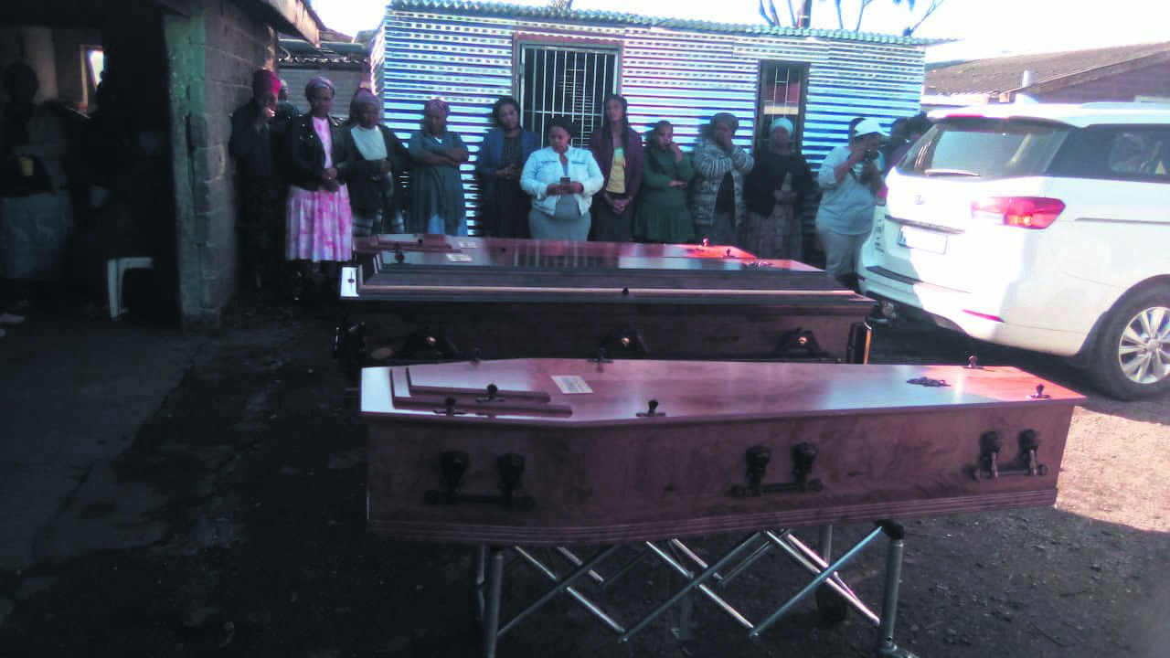 Community members held a short service before the coffins left on Saturday. 
