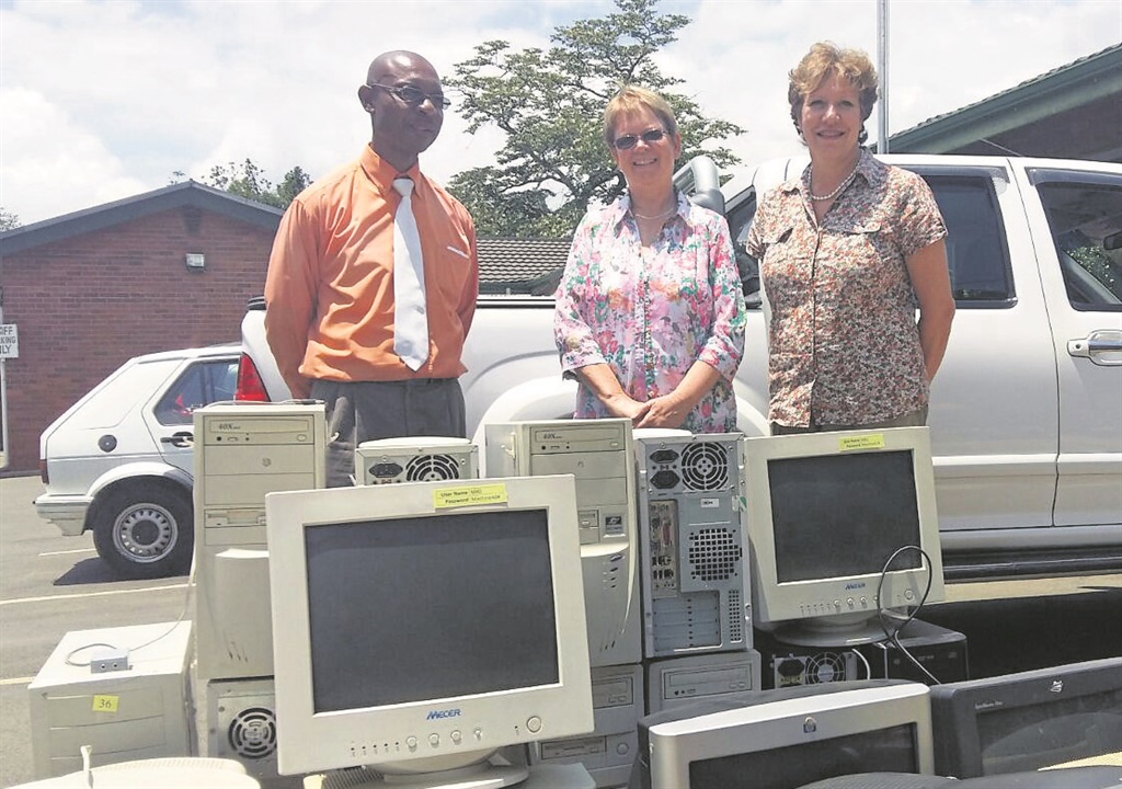 With the donated computers and printers (from left) Hlelingomuso deputy principal, Sipho Mnikath, Ridge principal Ann Dudley, and Ridge deputy principal, Sandra Pretorius. PHOTO: supplied  