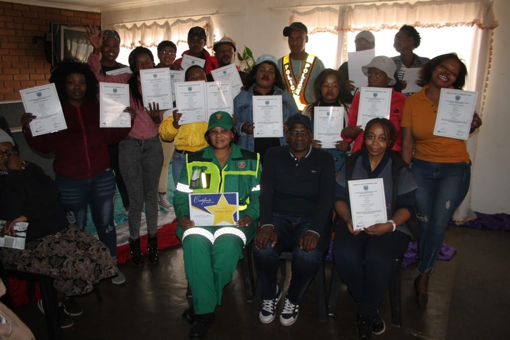 Community patrollers were awarded first aid certificates during the event by Brigadier Thembeka Gwebushe (seated, middle). Photo by Phineas Khoza