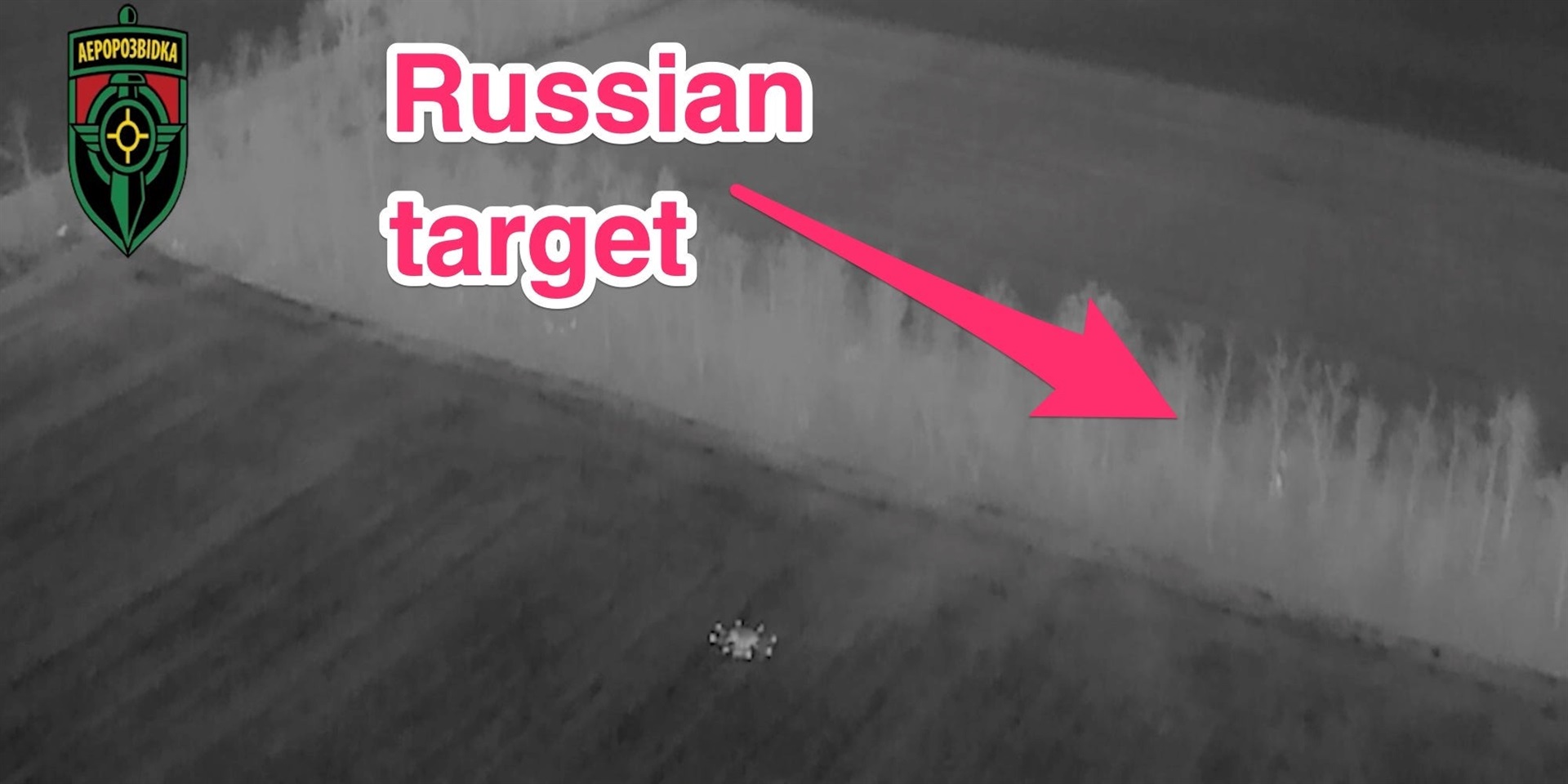 A black and white night view from an Aerorozvidka drone showing another drone in operation in Ukraine. An arrow added by Insider marks the target.