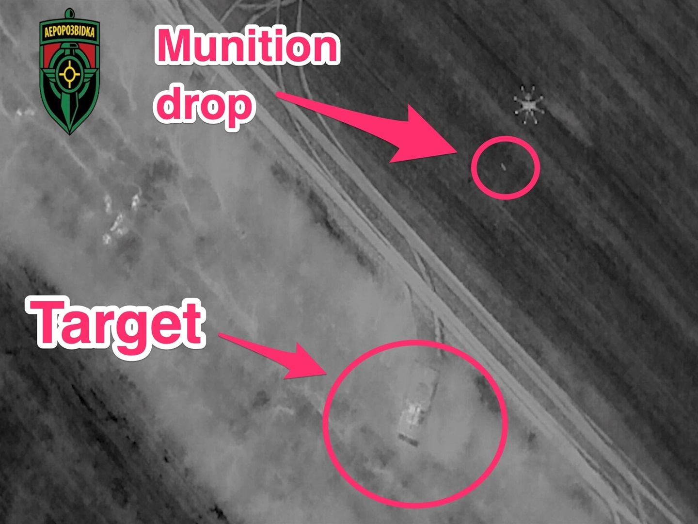 A black and white night view from an Aerorozvidka drone showing another drone in operation in Ukraine. Arrows added by Insider mark the target and the ammo being dropped.