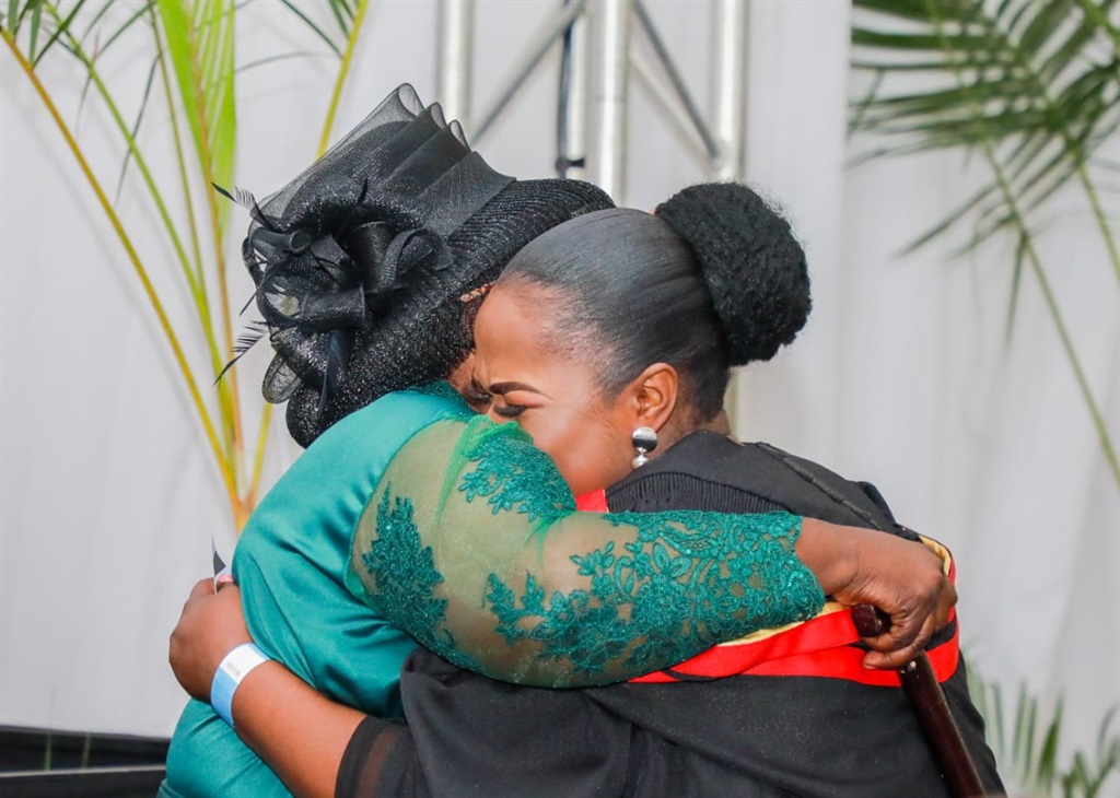 Nontokozo Ntuli and her mother, Sebenzile,  embrace one another after she received her degree in teaching from the Durban University of Technology.