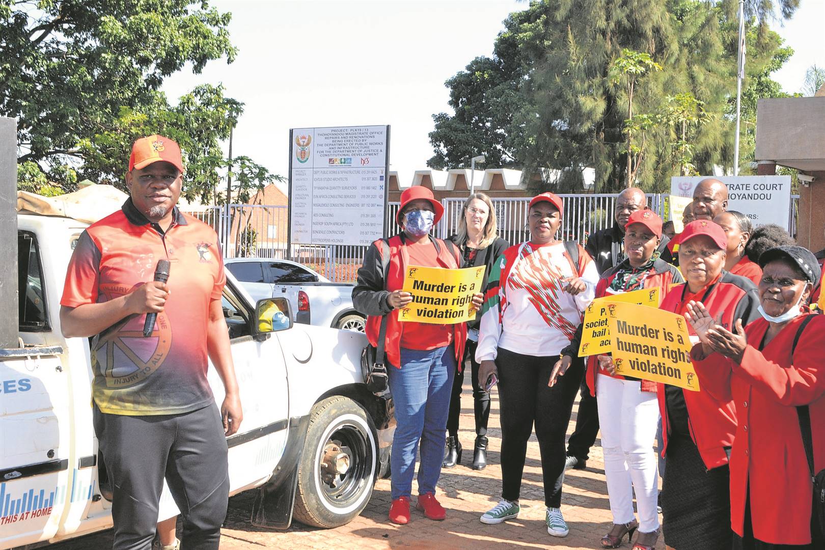 Cosatu’s provincial secretary Gerald Twala (left), union members and residents picket outside the court to support the families of the two Vhembe Samwu officials who were gunned down in separate incidents three years ago. Photo by Silas Nduvheni