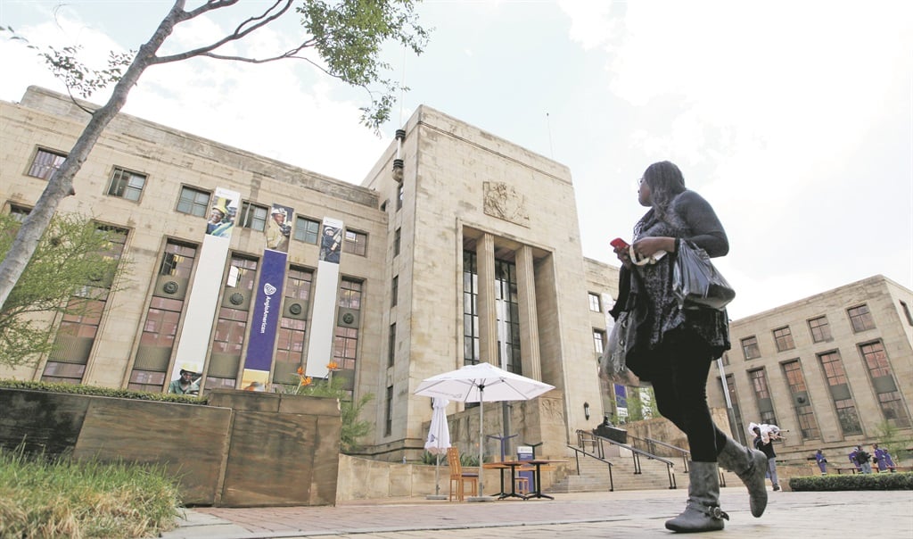MUSSOLINI POST OFFICE A pedestrian looks at the offices of Anglo American, which Sir Ernest Oppenheimer asked to be designed as a marriage between a cathedral and a mine, in Marshalltown, Johannesburg.  Picture: Chris Ratcliffe / Bloomberg via Getty Images 