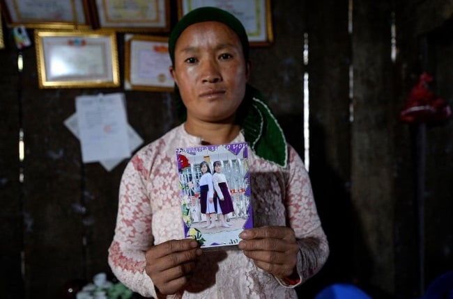 A mom holds a photograph of her missing teenaged daughter Dua. Many people from her part of Vietnam have a story about bride trafficking, similar to the custom of ukuthwala practised in SA.