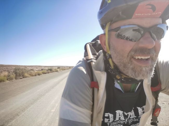 The face of a rider, who is actually enjoying riding the bike he designed, across South Africa. (Photo: Sling Cycles)