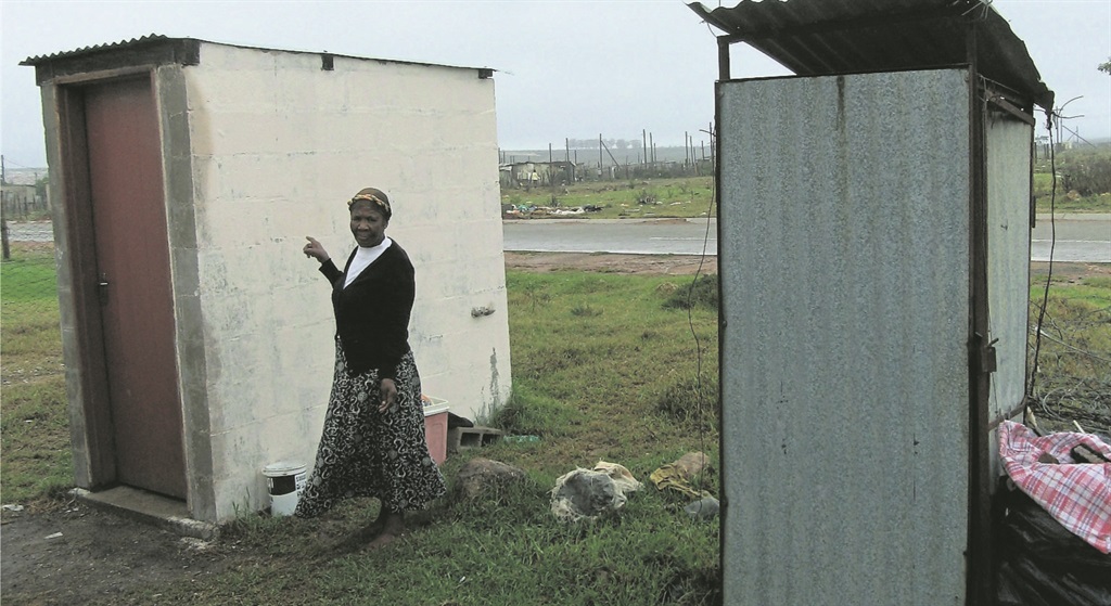 Nomathamsanqa stands next to the toilet she still can’t use. Photo by Sivuyile Ndawuni 