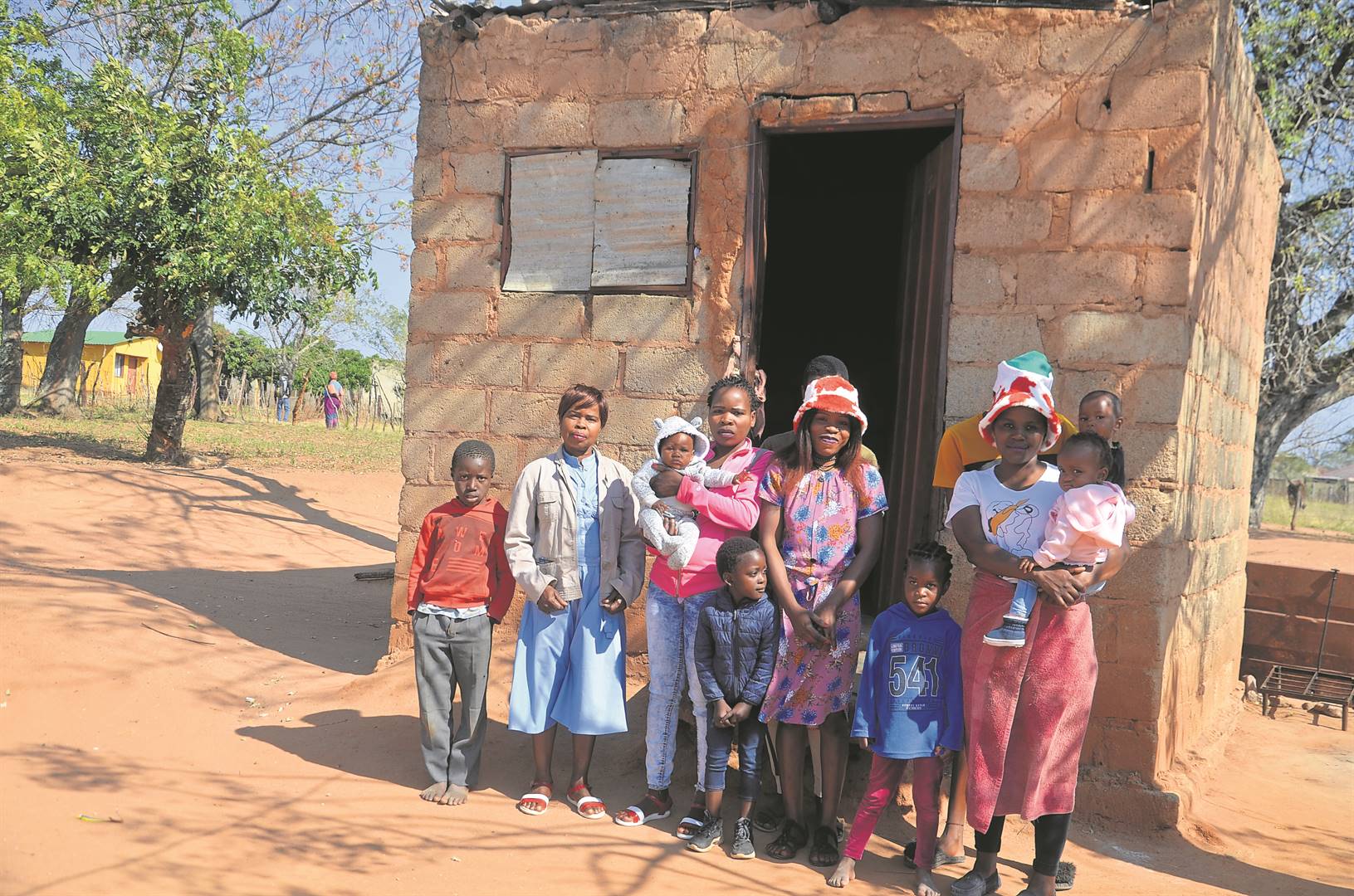 Single mum Lucie Manyike with her children and grandchildren in front of their small and rundown house.                          Photo by Oris Mnisi 