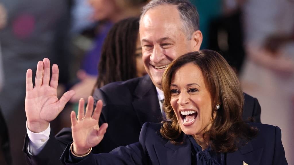 US Vice President and 2024 Democratic presidential candidate Kamala Harris and her husband US Second Gentleman Douglas Emhoff wave from the stage on the fourth and last day of the Democratic National Convention (DNC) at the United Center in Chicago, Illinois. (Charly Triballeau/AFP)