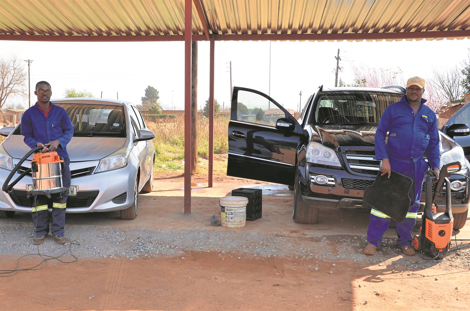 Kagiso Molefe and Moses Kgosiesile at their car wash in Koster, North West.      Photo by Rapula Mancai